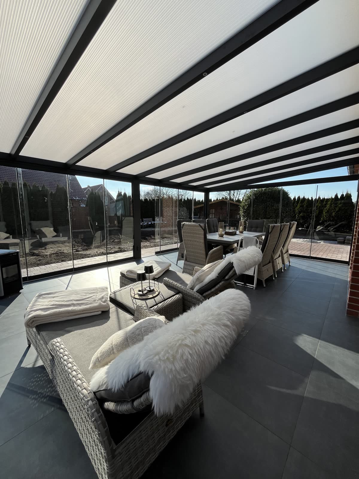 Blick von innen unter ein Glasdach einer Aluminium-Terrassenüberdachung
